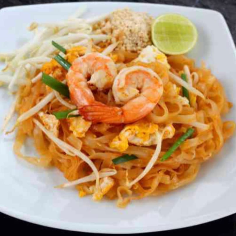 Red Jasmine Thai Food & Pho's Pad Thai with shrimp, bean sprouts, crushed peanuts, and lime.